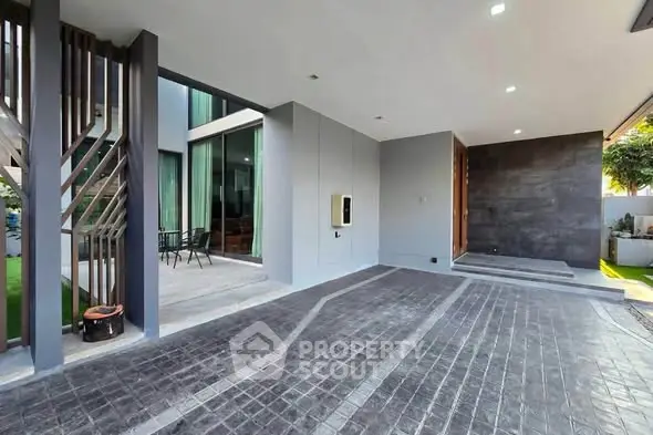 Modern building entrance with sleek design and spacious driveway