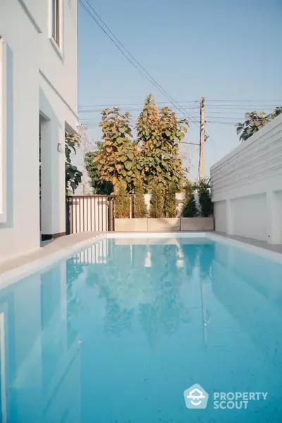 Stunning private pool area with modern design and lush greenery, perfect for relaxation and entertainment.