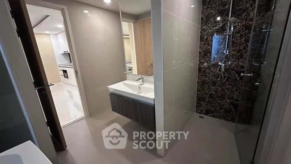 Modern bathroom with sleek design and glass shower in contemporary apartment