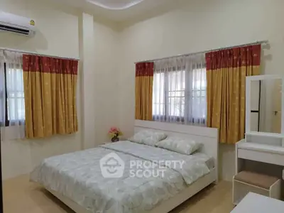 Cozy bedroom with modern decor and ample natural light, featuring a comfortable bed and stylish curtains.