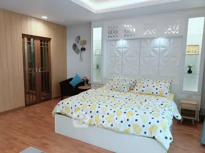 Spacious bedroom with modern decor and cozy ambiance