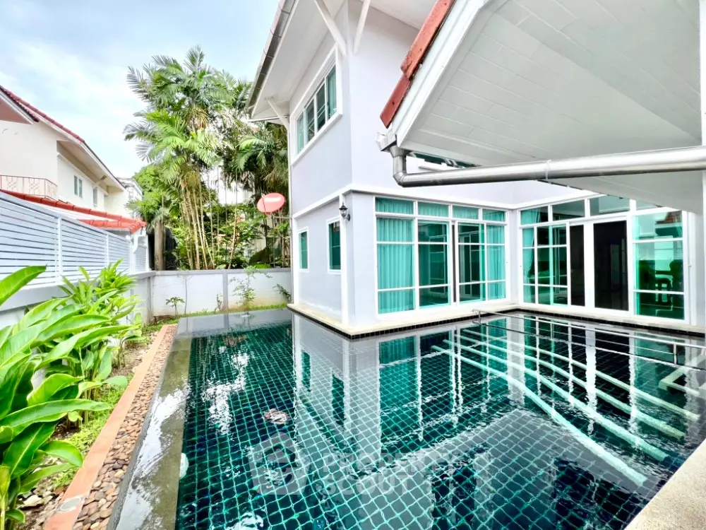 Luxurious home with private pool and lush greenery, perfect for relaxation and entertaining.