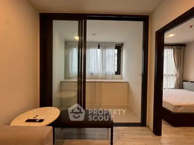 Modern apartment interior with cozy living area and bedroom, featuring stylish furniture and natural light.