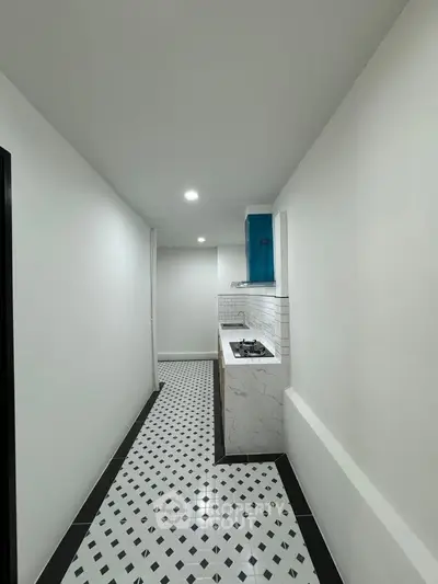 Modern narrow kitchen with sleek gas stove and stylish tile flooring