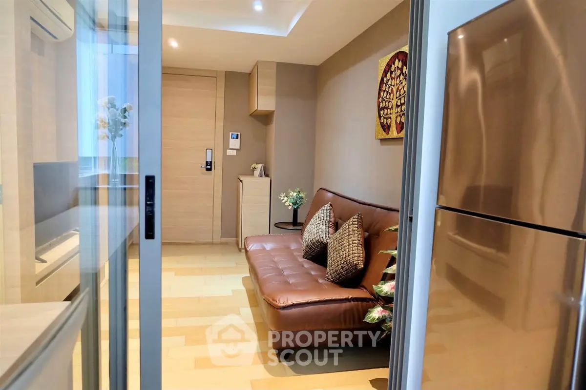 Modern living room with sleek design and stainless steel fridge