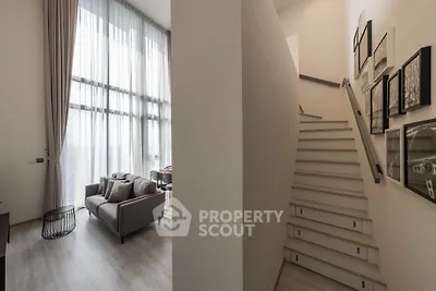 Modern duplex apartment with high ceilings and elegant staircase