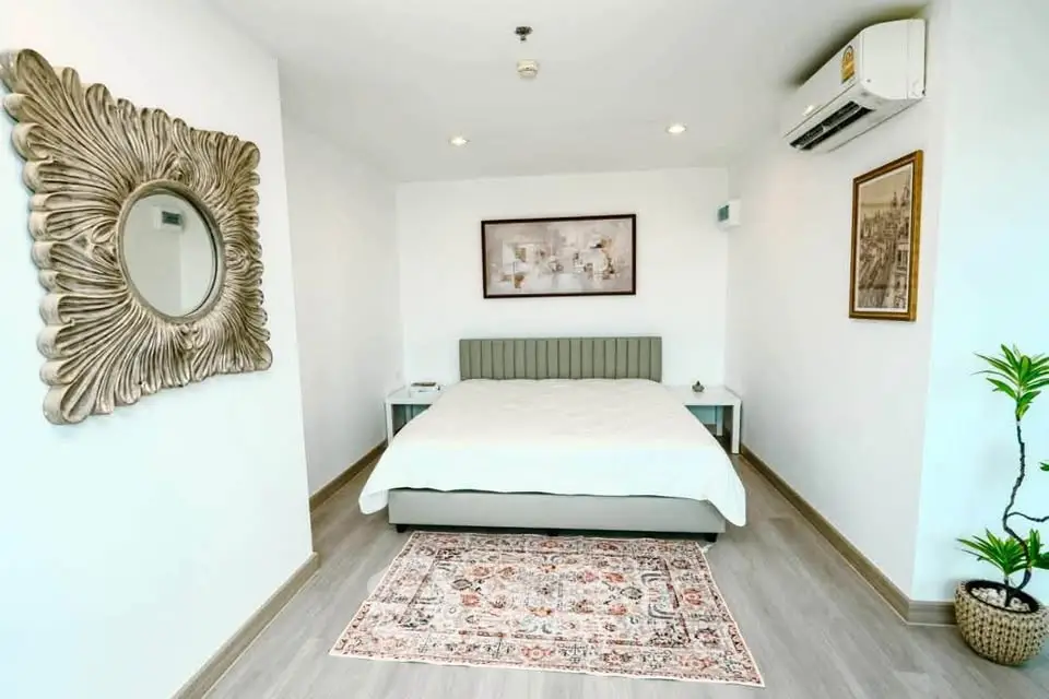 Modern bedroom with stylish decor and air conditioning in a cozy apartment.