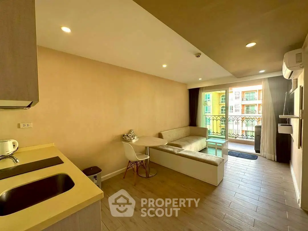 Modern living room with open kitchen and balcony view