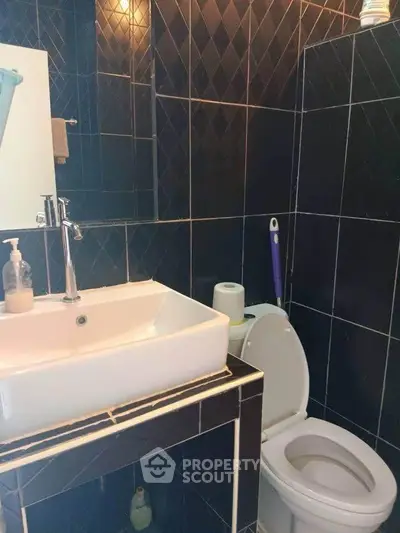 Modern bathroom with sleek black tiles and contemporary fixtures