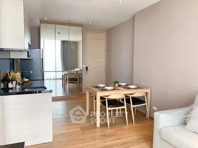 Modern open-plan living and dining area with sleek kitchen and stylish decor.