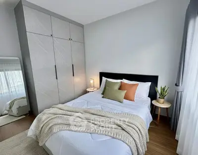 Cozy modern bedroom with stylish decor and ample natural light
