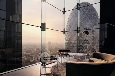 Luxurious modern living room with stunning city view and iconic architecture.