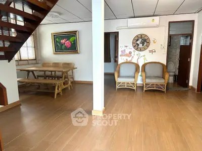 Spacious living area with wooden flooring and cozy seating