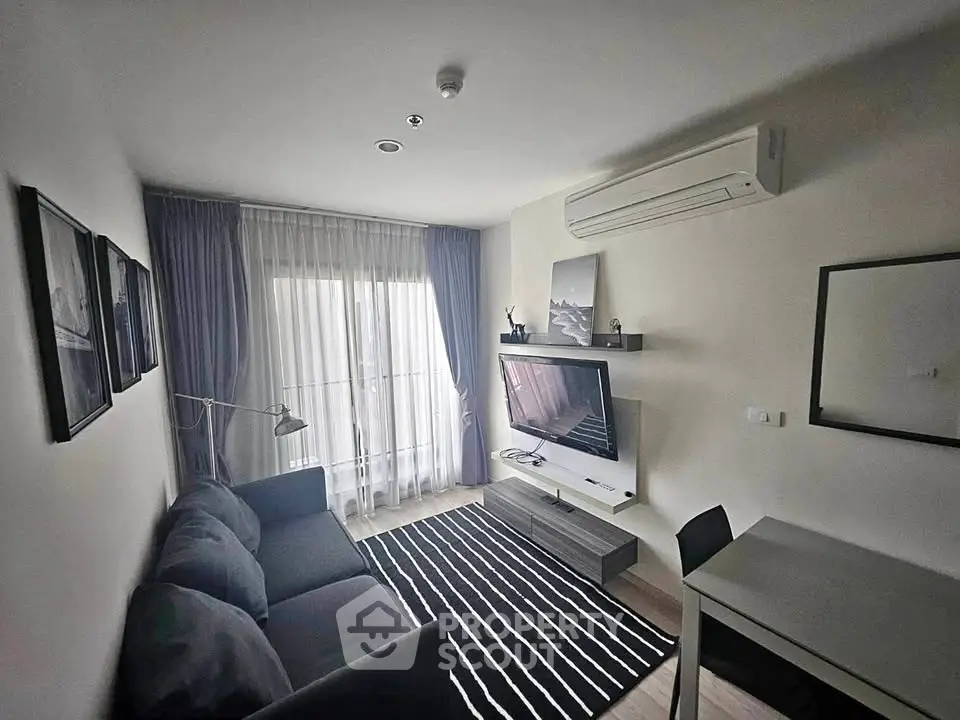 Modern living room with sleek furniture and natural light, featuring a stylish sofa and wall-mounted TV.