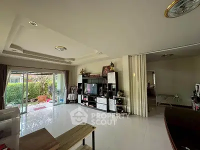 Spacious living room with garden view and modern entertainment center