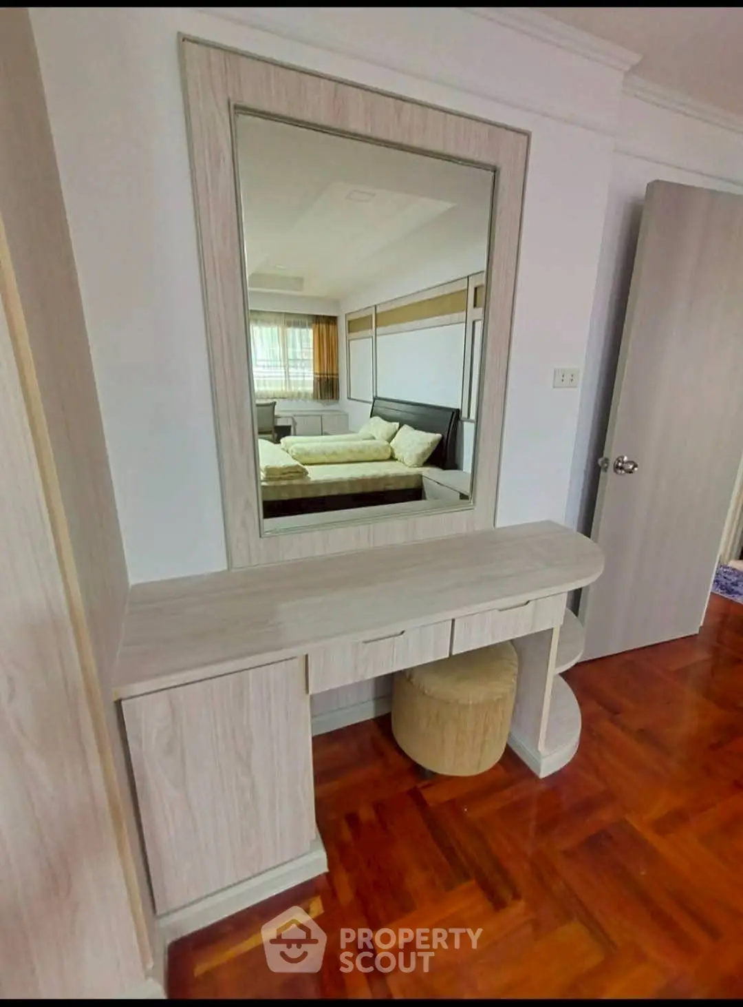 Stylish bedroom with elegant wooden furniture and large mirror