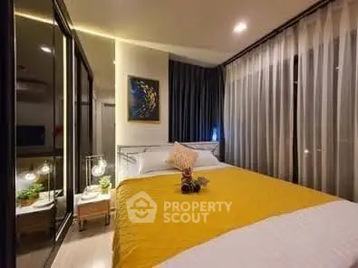 Modern bedroom with elegant decor and large windows in a stylish apartment.
