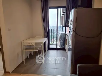 Modern kitchen with dining area and city view from balcony.