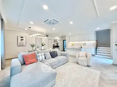 Spacious modern living room with elegant decor and open kitchen layout