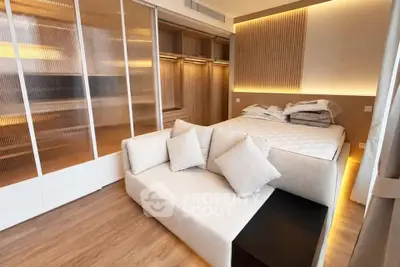 Luxurious bedroom with modern design, featuring a cozy bed, elegant lighting, and spacious walk-in closet.