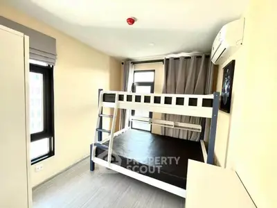 Modern bedroom with bunk bed and air conditioning in bright apartment