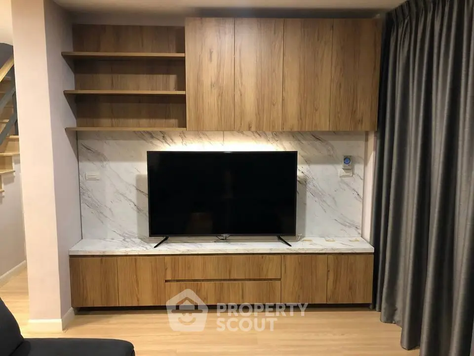 Modern living room with sleek wooden TV cabinet and marble accents