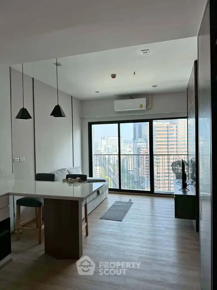 Modern living room with city view and sleek furniture in high-rise apartment