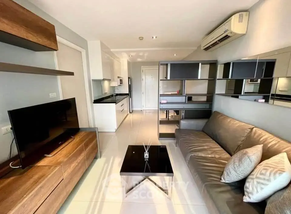 Modern living room with sleek furniture and open kitchen layout, perfect for contemporary living.