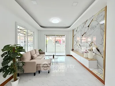 Elegant living room with marble accent wall and cozy seating area