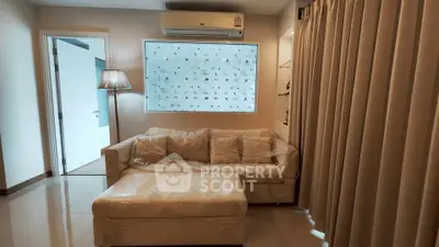 Modern living room with air conditioning and stylish sofa in a cozy apartment.