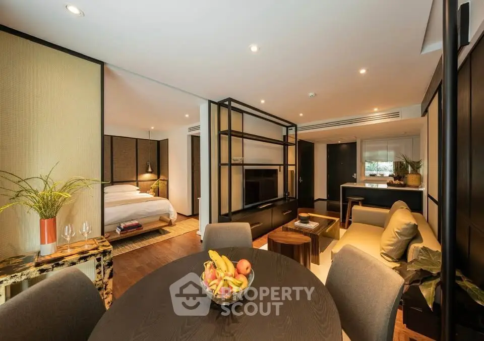Luxurious open-plan living room with modern decor and cozy bedroom view