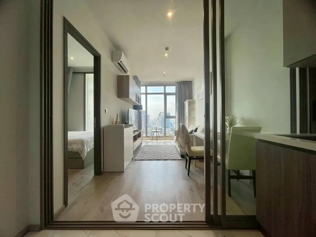 Modern apartment with open layout and city view, featuring stylish decor and natural light.