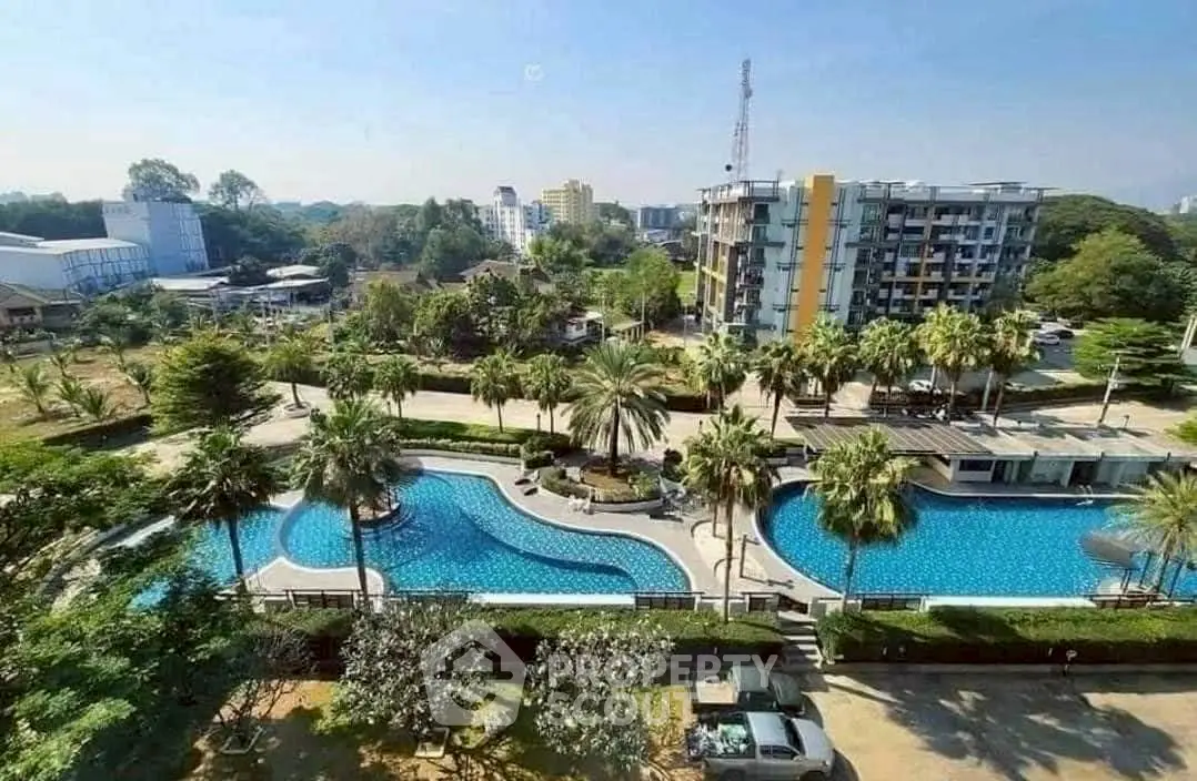 Luxurious residential complex with stunning pool and lush greenery, offering a serene urban oasis.