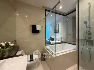 Luxurious bathroom with glass shower and bathtub in modern apartment