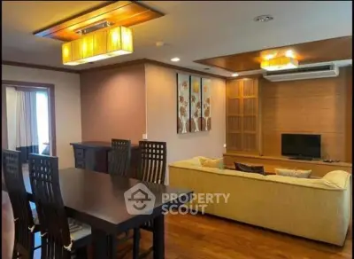 Spacious living room with modern decor and dining area in elegant apartment.