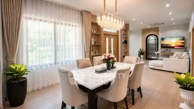 Luxurious open-plan living and dining area with elegant chandelier and modern decor.