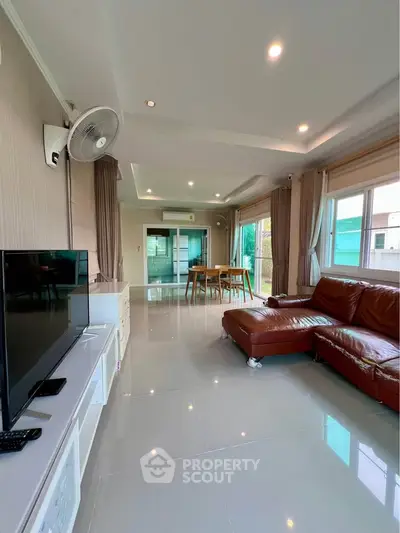 Spacious living room with modern decor and large windows for natural light.