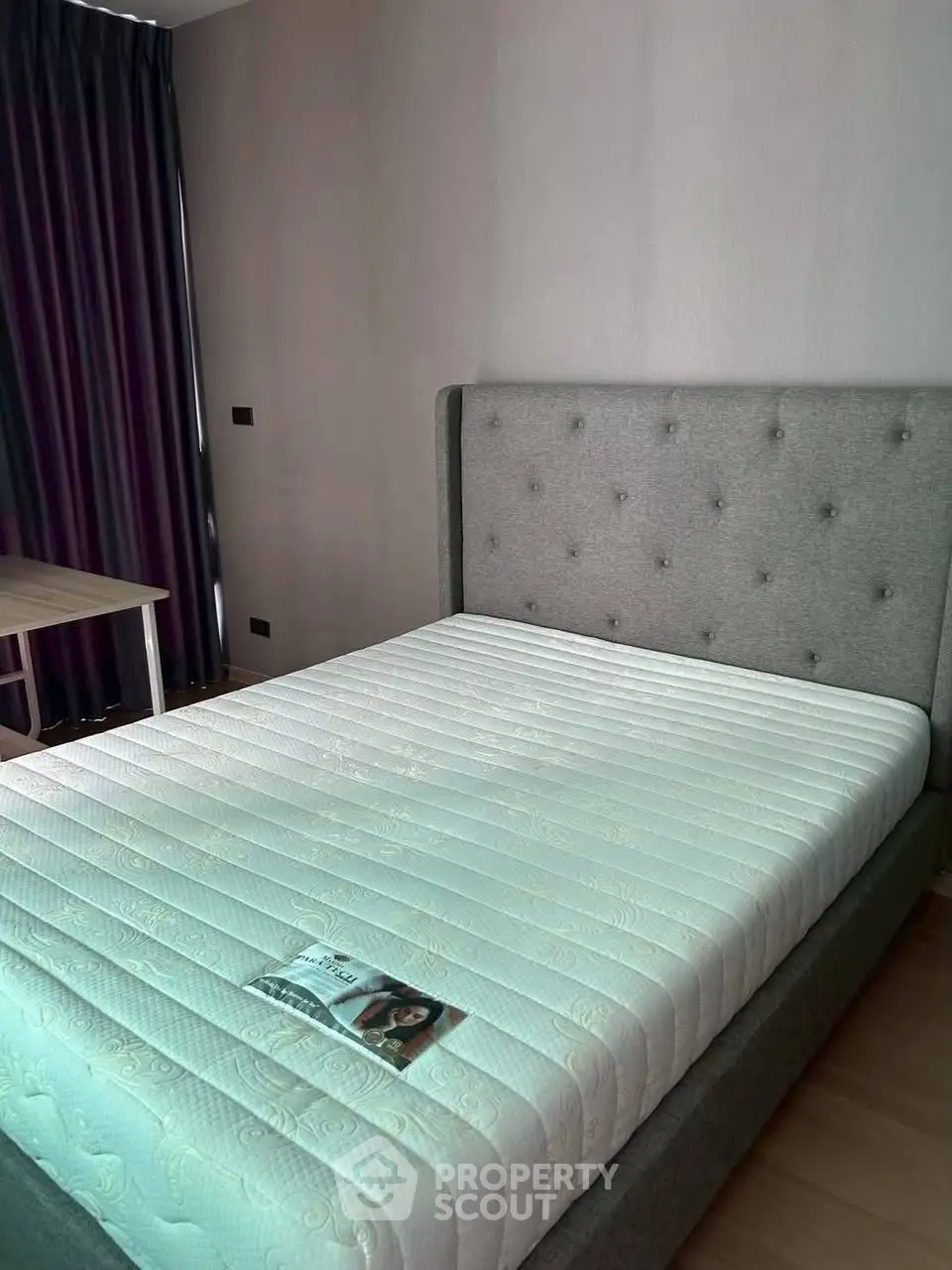 Modern bedroom with stylish bed and elegant curtains, perfect for a cozy retreat.