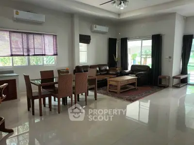 Spacious living room with modern furniture and large windows offering natural light.