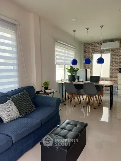 Modern living room with stylish dining area and blue sofa