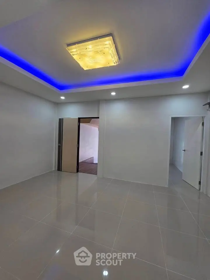 Modern interior with sleek tile flooring and ambient ceiling lighting, perfect for contemporary living.