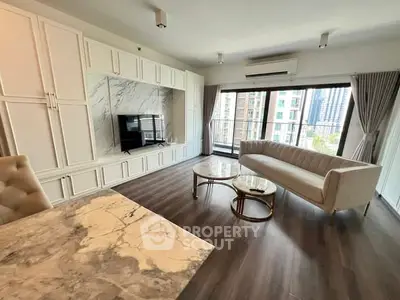 Luxurious living room with elegant marble accents and city view balcony.
