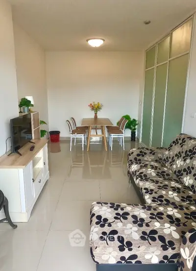 Modern living room with stylish furniture and dining area, perfect for cozy gatherings.