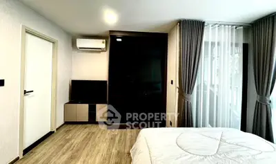 Modern bedroom with sleek design, featuring a large window and stylish curtains, perfect for relaxation.