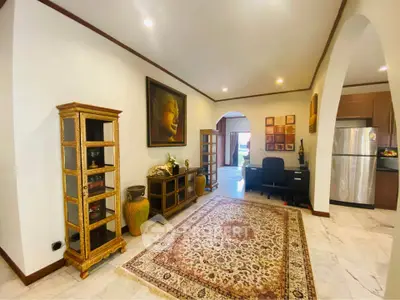 Elegant living room with ornate decor and modern kitchen appliances