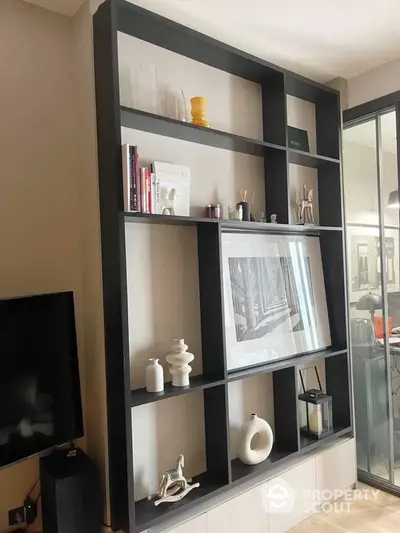 Elegant modern shelving unit in a stylish living space, showcasing a mix of decorative items and books, perfect for a contemporary home.