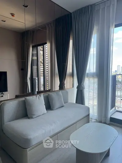 Modern living room with stylish sofa and city view balcony in luxury apartment.