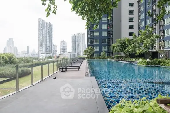 Luxurious high-rise apartment with stunning pool and city skyline view.