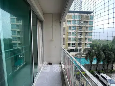 Spacious balcony with pool view in modern apartment complex