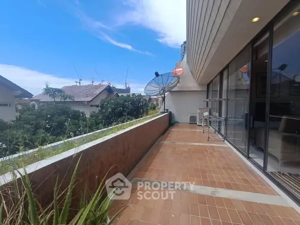 Spacious balcony with city view and satellite dishes, perfect for relaxation.